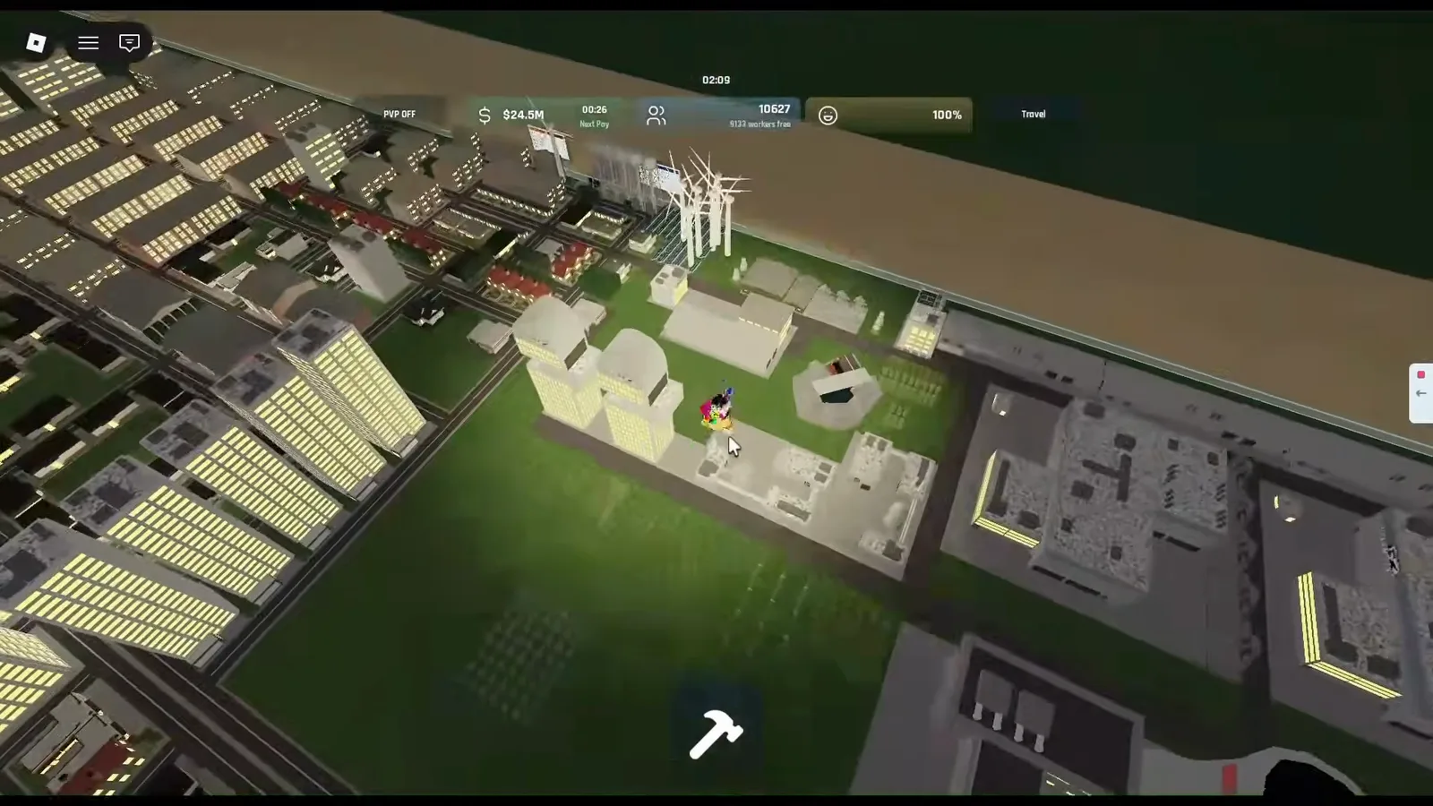 Build and Conquer Roblox night aerial view of dense gray towers and green blocks separated from flat tan terrain by a thin blue boundary line, with wind turbines in the distance.